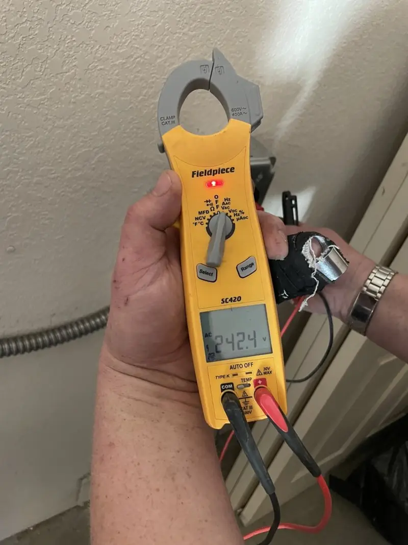 Voltage testing with clamp meter during Electrical Installation Services in Saylorville